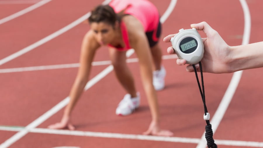 Coach timing athlete on track