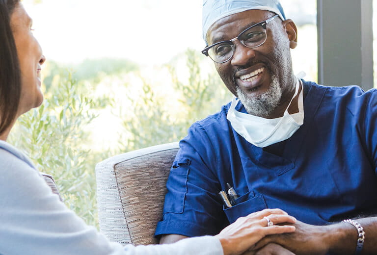 physician sitting and looking at woman