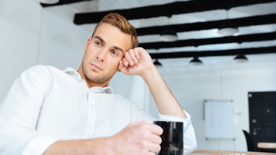 Man spaced out at desk.